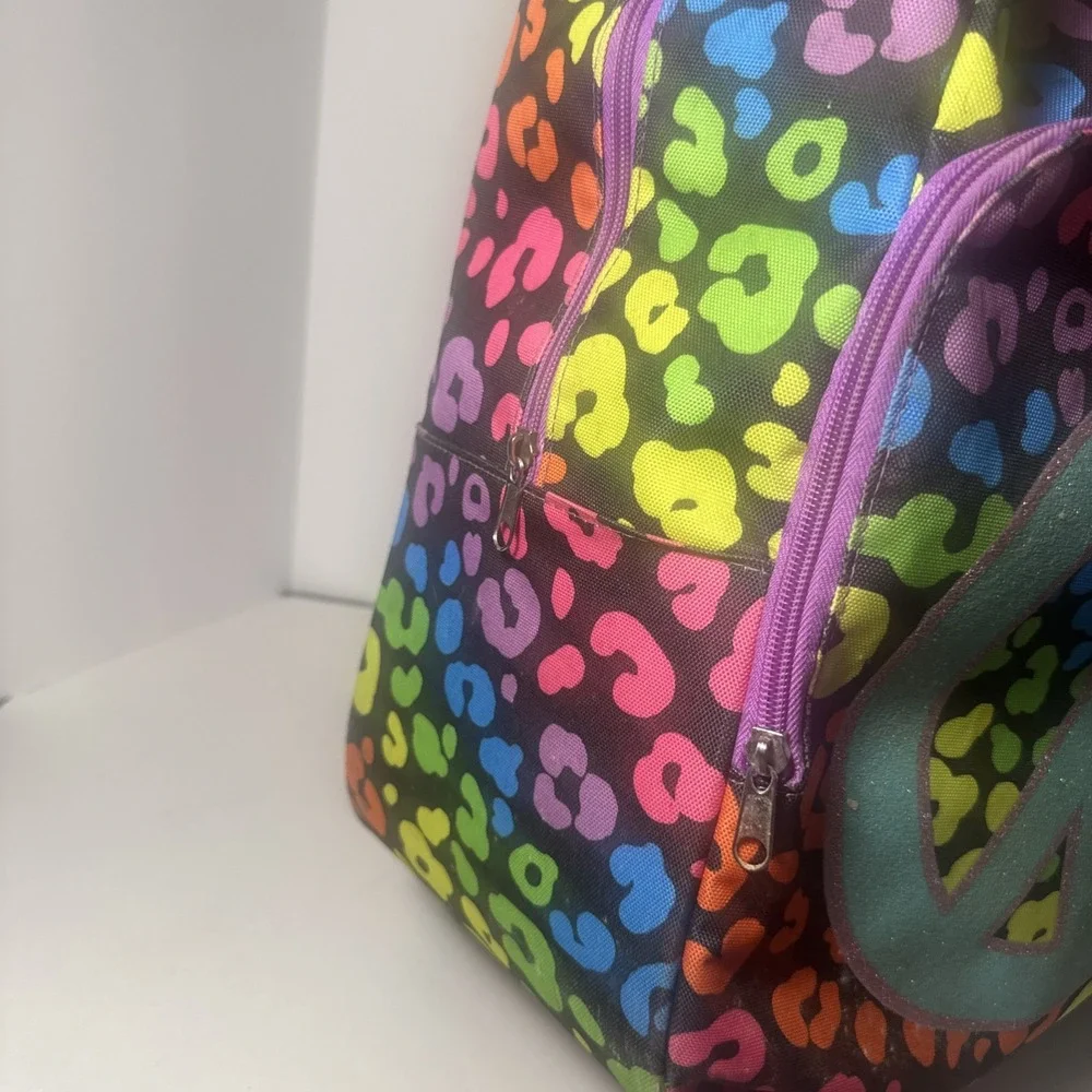Justice Brand Rainbow Color Peace Sign Rolling Travel Bag Pre-owned‎